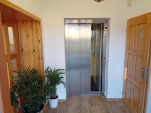 an elevator in a room with two potted plants at Zámecký Dvůr Černousy in V Poli