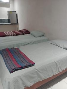 2 łóżka w pokoju z białymi ścianami w obiekcie LOSSANTOS w mieście Matamoros