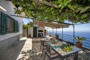 a table with food on it on a patio at Casa Giuseppina in Furore