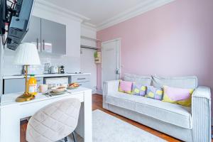 ein Wohnzimmer mit einem Sofa und einem Tisch in der Unterkunft Flat next to Montparnasse train station in Paris