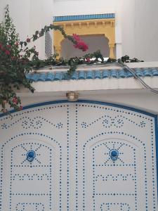 an open door with flowers on top of it at MAISON SIDI BOU SAID in Hammamet