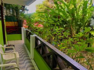 una veranda con sedie e piante su una casa di Le Petit Paradis a Roseau
