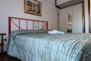 a bedroom with a bed with a towel on it at Nina House in Desenzano del Garda