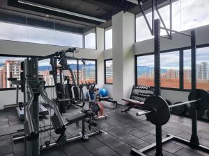 a gym with cardio equipment in a building with windows at Apartamento de Lujo in Guatemala