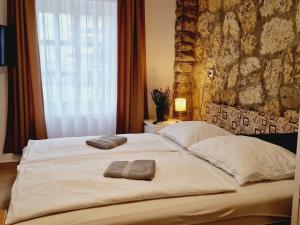 a bedroom with two beds with towels on them at Balaton Apartman Füred in Balatonfüred