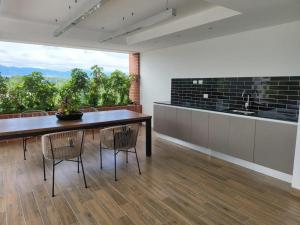 a dining room with a table and chairs with a view at Apartamento de Lujo in Guatemala