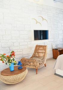 a rattan chair and a table in a living room at Keablue in Melissaki