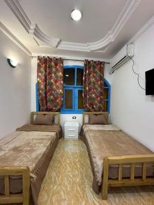 a bedroom with two beds and a window at Fresh studio in Dahab in Dahab