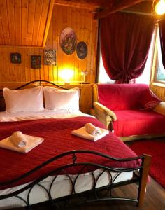 a bedroom with a bed with two towels on it at Pensiunea PORTAS RESORT in Slănic