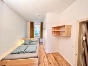 a small bedroom with a bed and a window at Central apartment in trendy Friedrichshain in Berlin