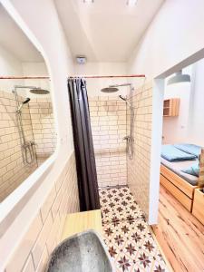 a bathroom with a shower and a tub at Central apartment in trendy Friedrichshain in Berlin