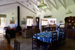 a dining room with a table and chairs in a room at Bamboo Mountain Farm in Underberg