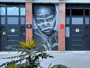 a large mural of a man on the side of a building at Loft África Benimaclet in Valencia