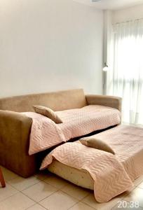 a bedroom with two beds and a couch at GÜEMES in Mar del Plata