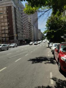 a street with cars parked on the side of the road at GÜEMES in Mar del Plata