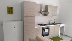 a kitchen with white cabinets and a stove top oven at Casa Veronica Boavista in Sal Rei