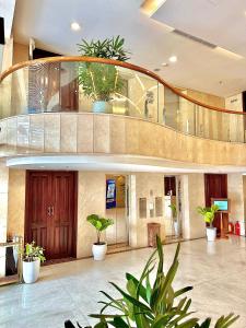 a lobby with potted plants in a building at NATURE Hotel By K D H in Da Nang