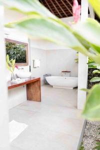 a bathroom with a toilet and a sink and a tub at Villa Tilu-spacious and serene 3 bedroom villa in Canggu in Canggu