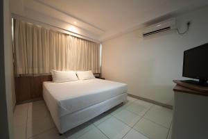 Cama o camas de una habitación en Premium Executive Hotel Itabira