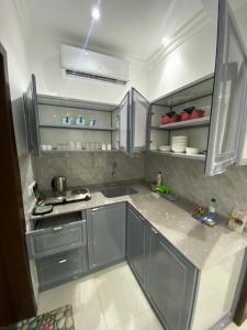 eine Küche mit Edelstahlschränken und einer Spüle in der Unterkunft ريحانه in Şabyā