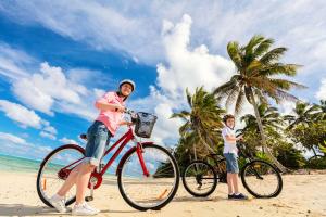 une femme et un garçon à vélo sur la plage dans l'établissement Jamaica Royale 2BR TownHome, à Siesta Key