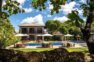 a villa with a swimming pool and a resort at Aquarela Praia Hotel in Arraial d'Ajuda