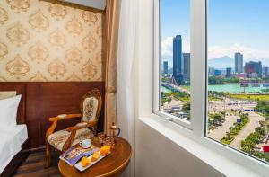 a room with a bed and a window with a view at NATURE Hotel By K D H in Da Nang