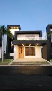 una casa blanca con una puerta delantera y una palmera en Exclusive Villa * private Beach and Housekeeping, en Punta Cana