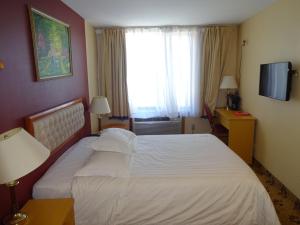 Postel nebo postele na pokoji v ubytování Flushing Hotel