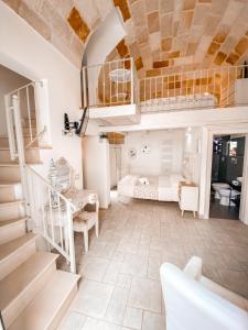 a living room with a staircase and a bedroom at Karen House B&B in Polignano a Mare