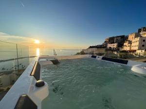 a hot tub on top of a building with the ocean at Suite Èlite Rooms in Peschici
