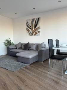 a living room with a couch and a table at Spacious 2BR with balcony in Brentwood in Brentwood