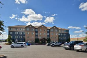 a parking lot with cars parked in front of a building at Staybridge Suites Las Cruces, an IHG Hotel in Las Cruces