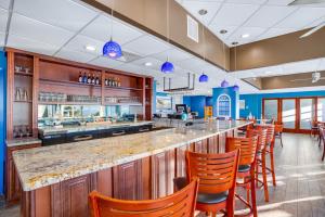 a bar in a restaurant with orange bar stools at Bay Watch 1941 in Myrtle Beach