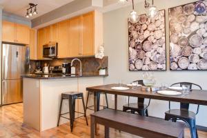 a kitchen with two dining tables and a kitchen with a counter at Grotto Canyon Chalet in Canmore