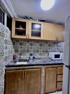 uma cozinha com um lavatório e um micro-ondas em Dar al anbar em Rabat
