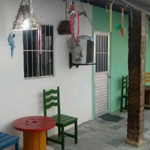 Habitación con mesa, sillas y mesa y sillas rojas. en Pousada em Fazenda Nova Dona Rosy en Fazenda Nova