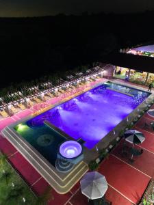 una vista aérea de una piscina por la noche en HOTEL & SPA LOS AGAVES, en Las Ánimas