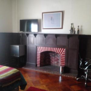 a living room with a red brick fireplace at Hostal María Luisa Bombal in Viña del Mar