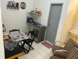 a small kitchen with a table and chairs in a room at Betesda 2197F in São Luís