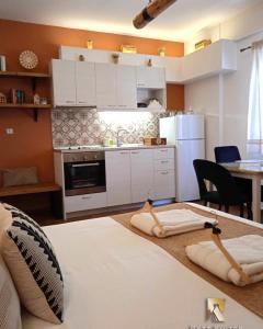 a kitchen with white cabinets and a table in a room at REST On The Pedestrian Street in Kalavrita