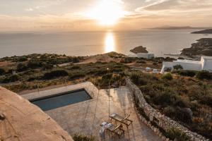a villa with a pool and a view of the ocean at Anemomilos in Koríthion