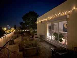 a patio with lights on a building at night at Village Vista Penthouse in Wesseling