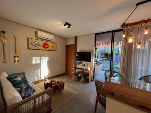 a living room with a couch and a table at Villa Sapê 9 in São Miguel dos Milagres