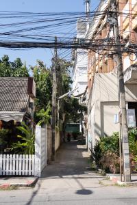 an alley way with a building and power lines at Chiang Mai Mansion in Chiang Mai