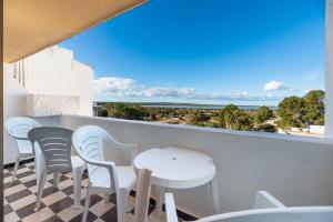 einen Balkon mit einem Tisch und Stühlen sowie Meerblick in der Unterkunft Apartamento Bilo 301 in Es Pujols