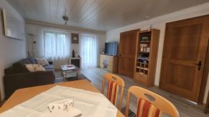 a living room with a table and a couch at Ferienwohnung Karin in Bludenz