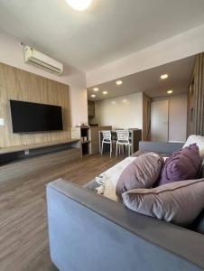 a living room with a couch and a flat screen tv at Aparthotel Astron in Salvador