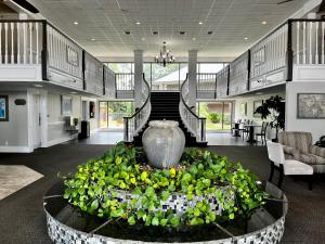 a lobby with a large vase in the middle at At Home Inn - Pensacola in Pensacola