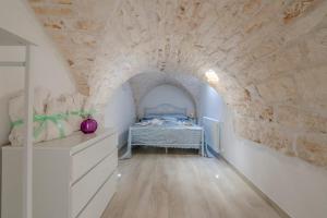 A bed or beds in a room at Le Alcove del Leopardi